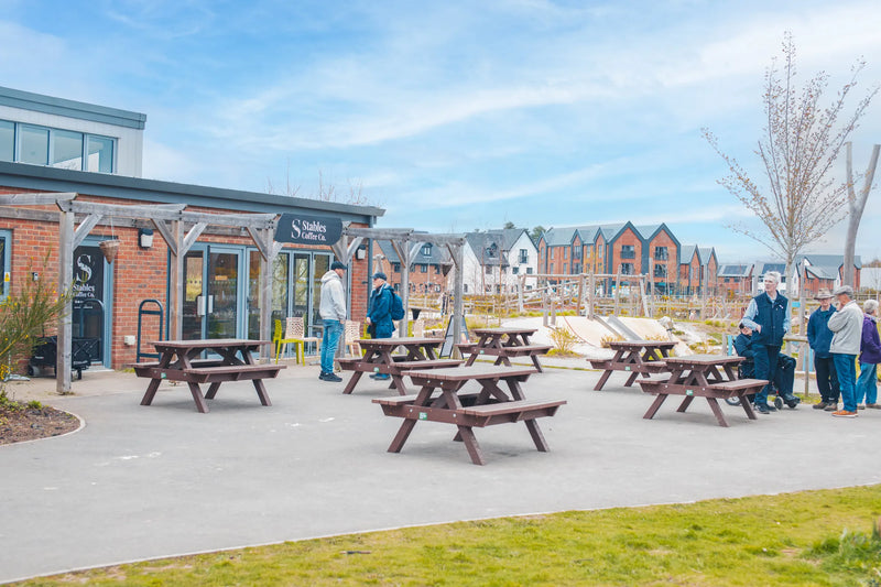 Outdoor seating area with picnic tables in a community setting3